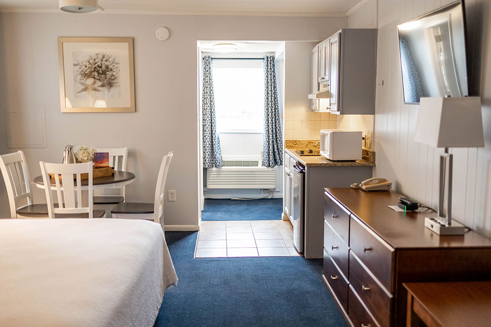Hotel room with a king-size bed and small kitchenette